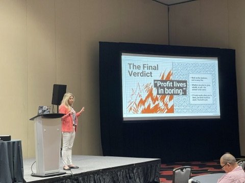 Jessica Holder presenting on stage at an insurance industry conference